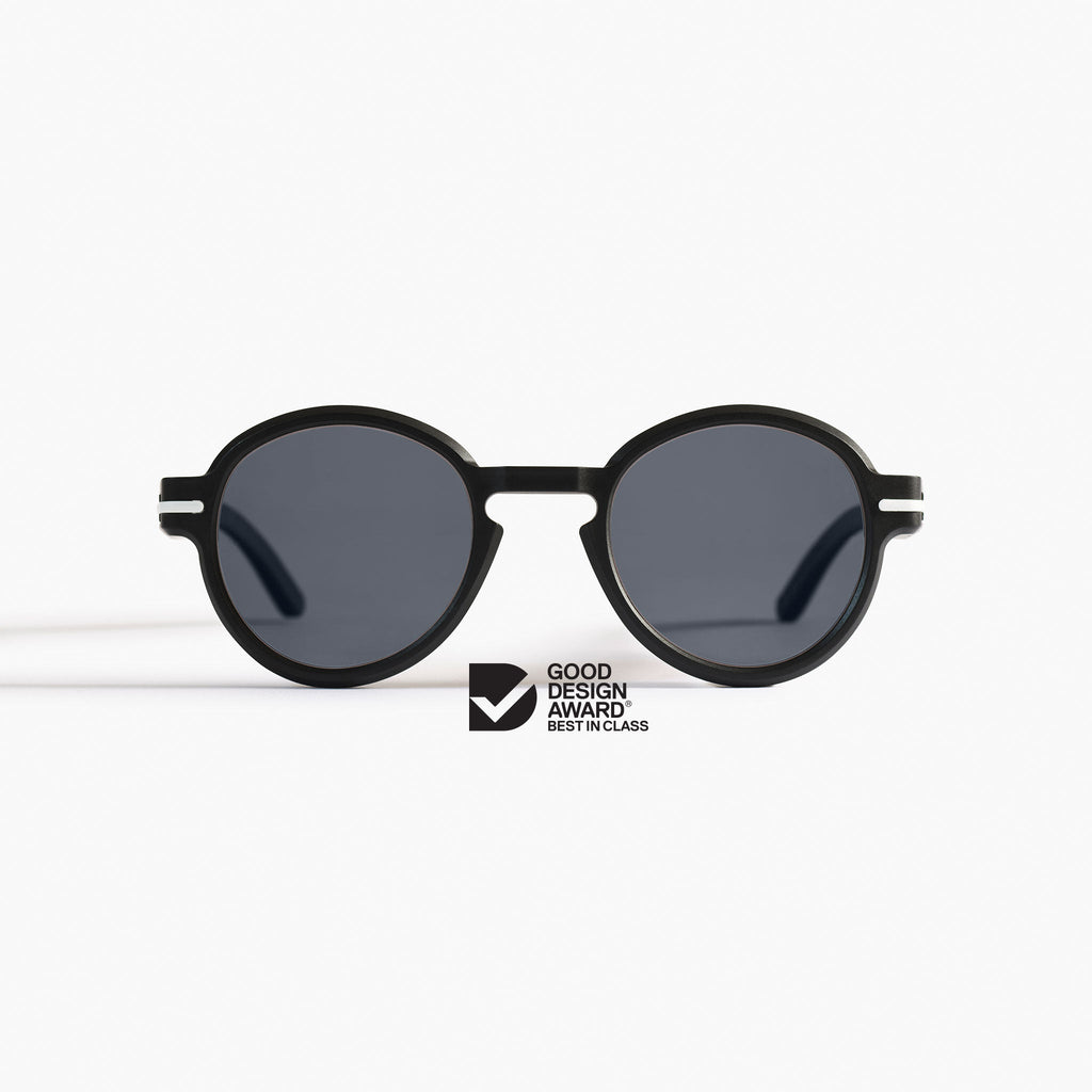 Good Citizens black round sunglasses with Carl Zeiss Vision lenses, crafted from 100% recycled plastic, on a white background