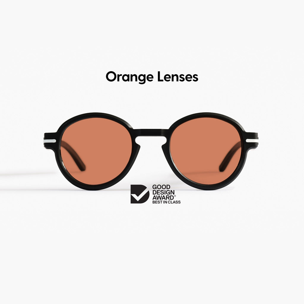 Good Citizens round black sunglasses on a white background with orange Carl Zeiss lenses and 100% recycled plastic frame
